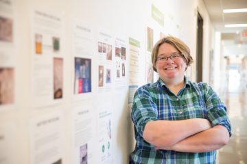 Dr. Reini Kappelhoff, research associate and lab manager of the Overall Lab, in UBC’s Centre for Blood Research, in front of her “Tips for Recycling” wall. Photo by: Ricardo Seah